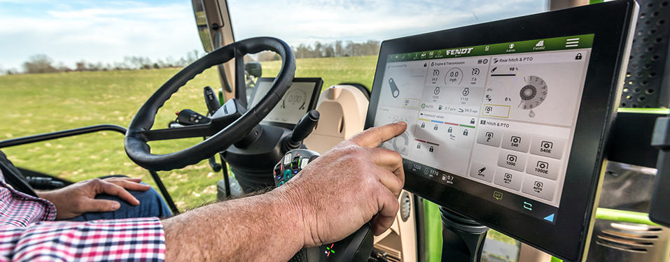 Close up of hand interacting with screen in a tractor